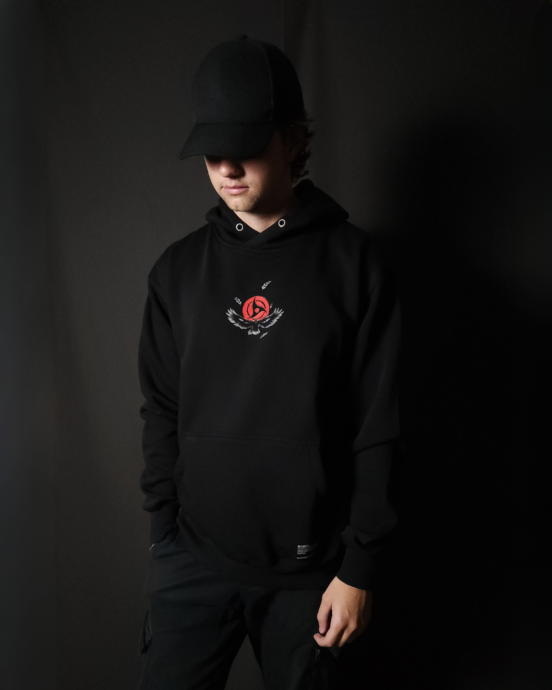 Anime-inspired apparel featuring bold back artwork, worn by a model in a dark studio setting – from a South African anime clothing brand.