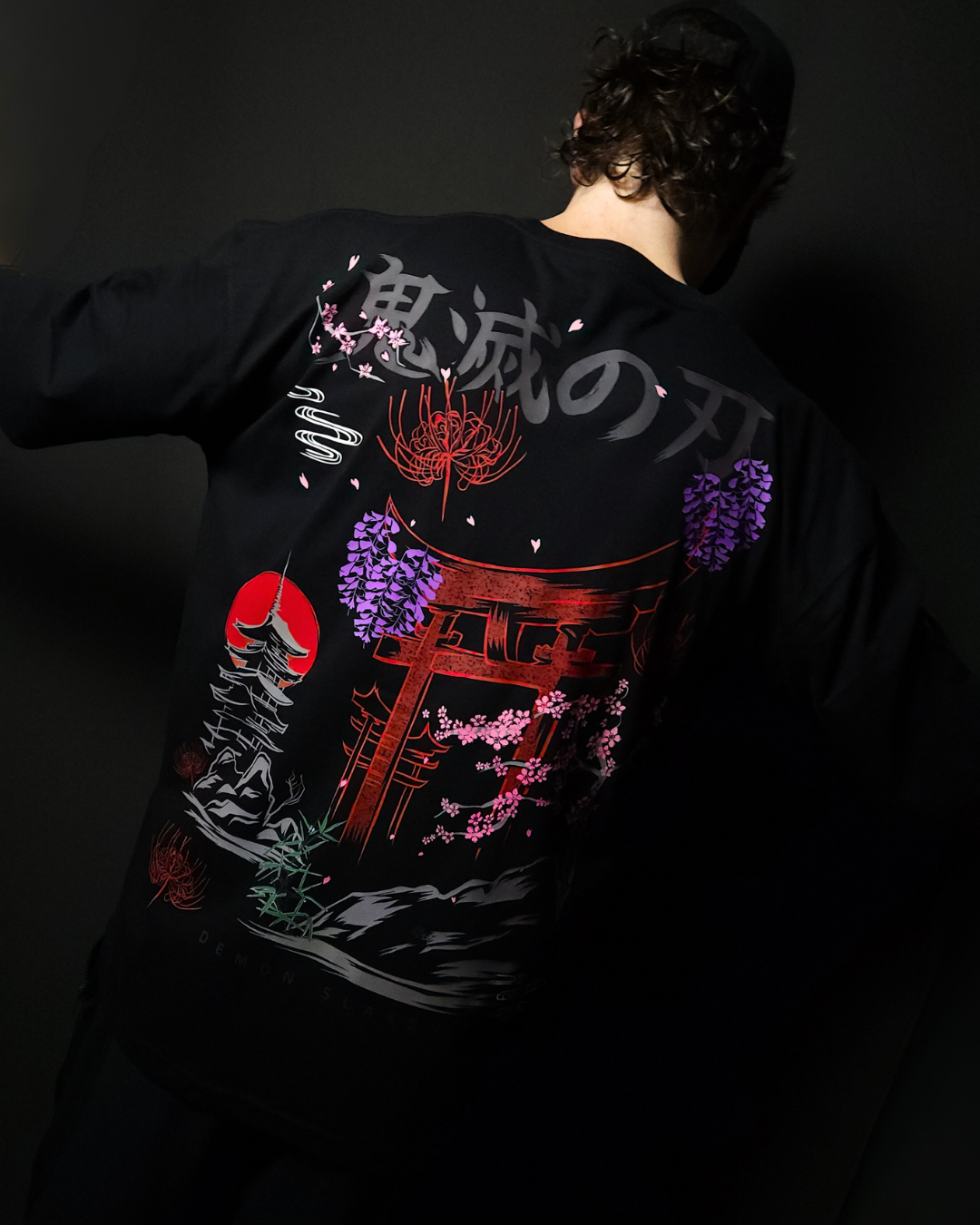 Anime-inspired apparel featuring bold back artwork, worn by a model in a dark studio setting – from a South African anime clothing brand.