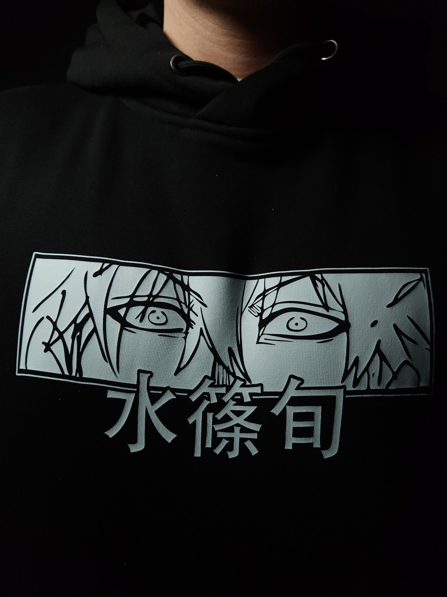 Anime-inspired apparel featuring bold back artwork, worn by a model in a dark studio setting – from a South African anime clothing brand.