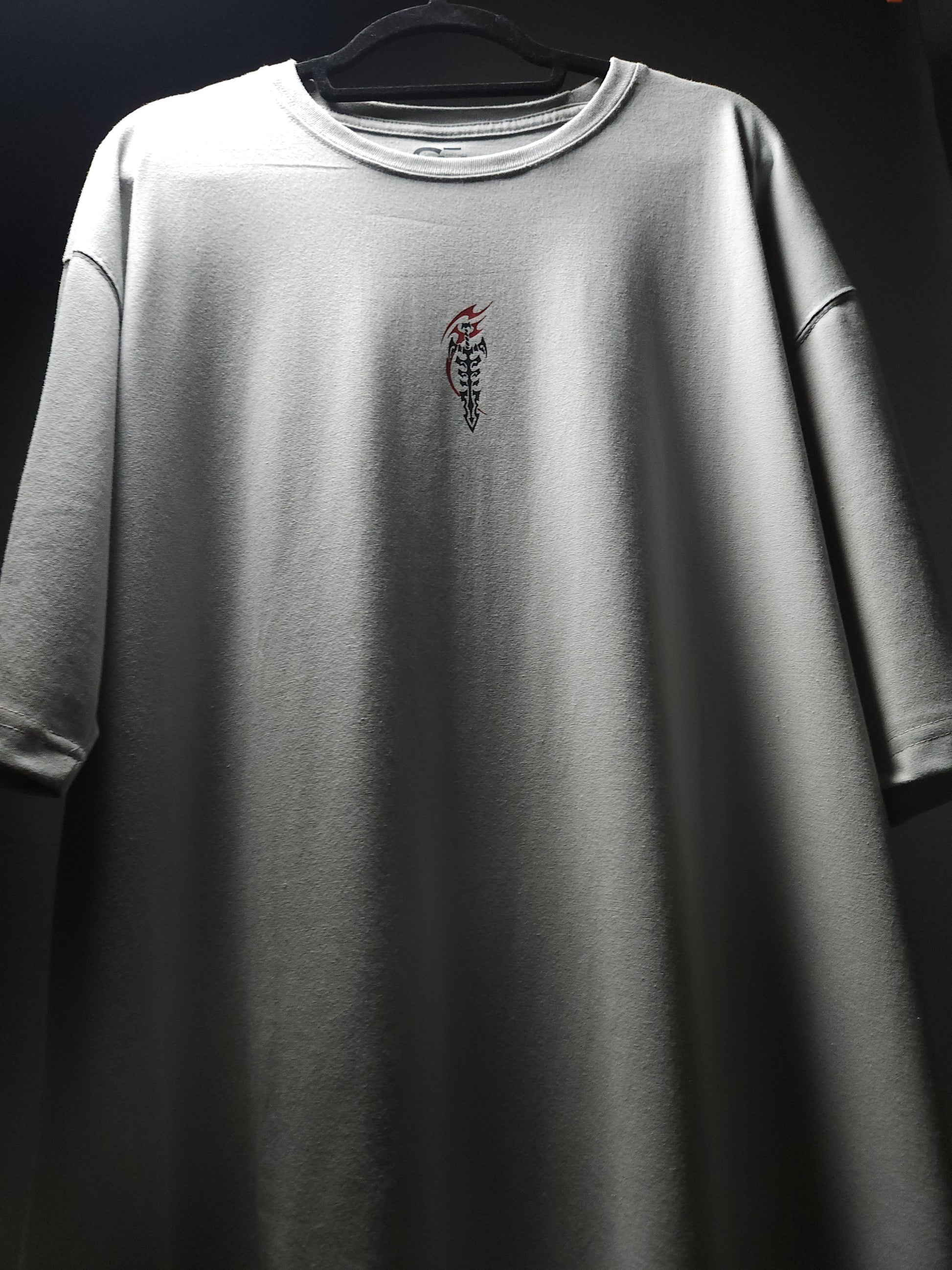 Anime-inspired apparel featuring bold back artwork, worn by a model in a dark studio setting – from a South African anime clothing brand.