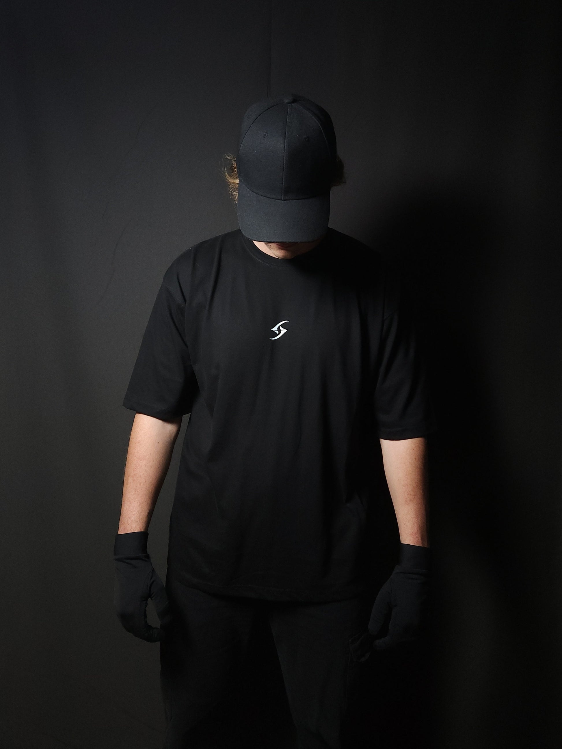 Anime-inspired apparel featuring bold back artwork, worn by a model in a dark studio setting – from a South African anime clothing brand.