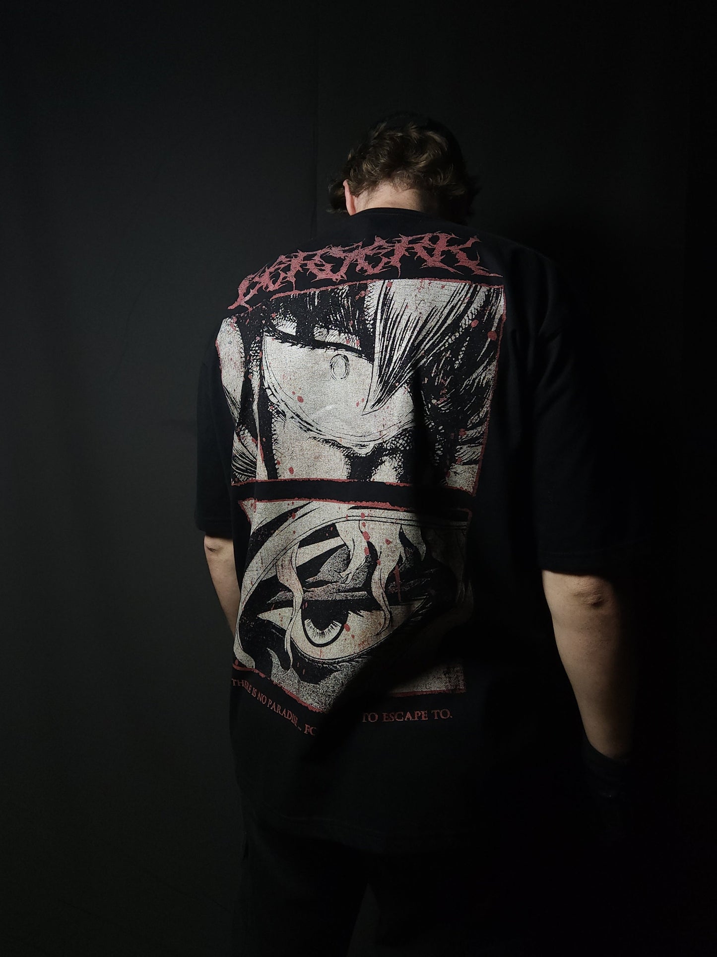 Anime-inspired apparel featuring bold back artwork, worn by a model in a dark studio setting – from a South African anime clothing brand.