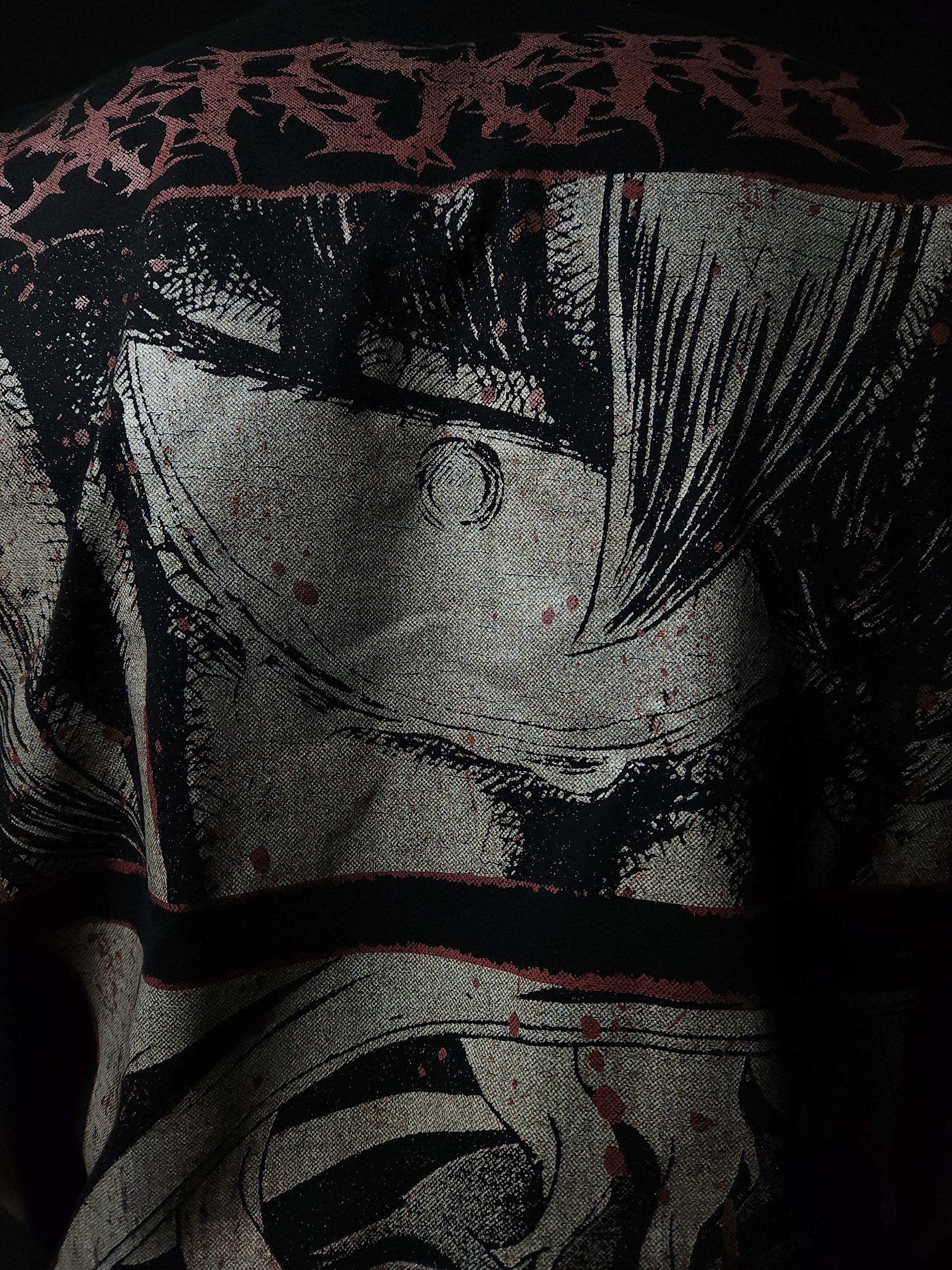 Anime-inspired apparel featuring bold back artwork, worn by a model in a dark studio setting – from a South African anime clothing brand.