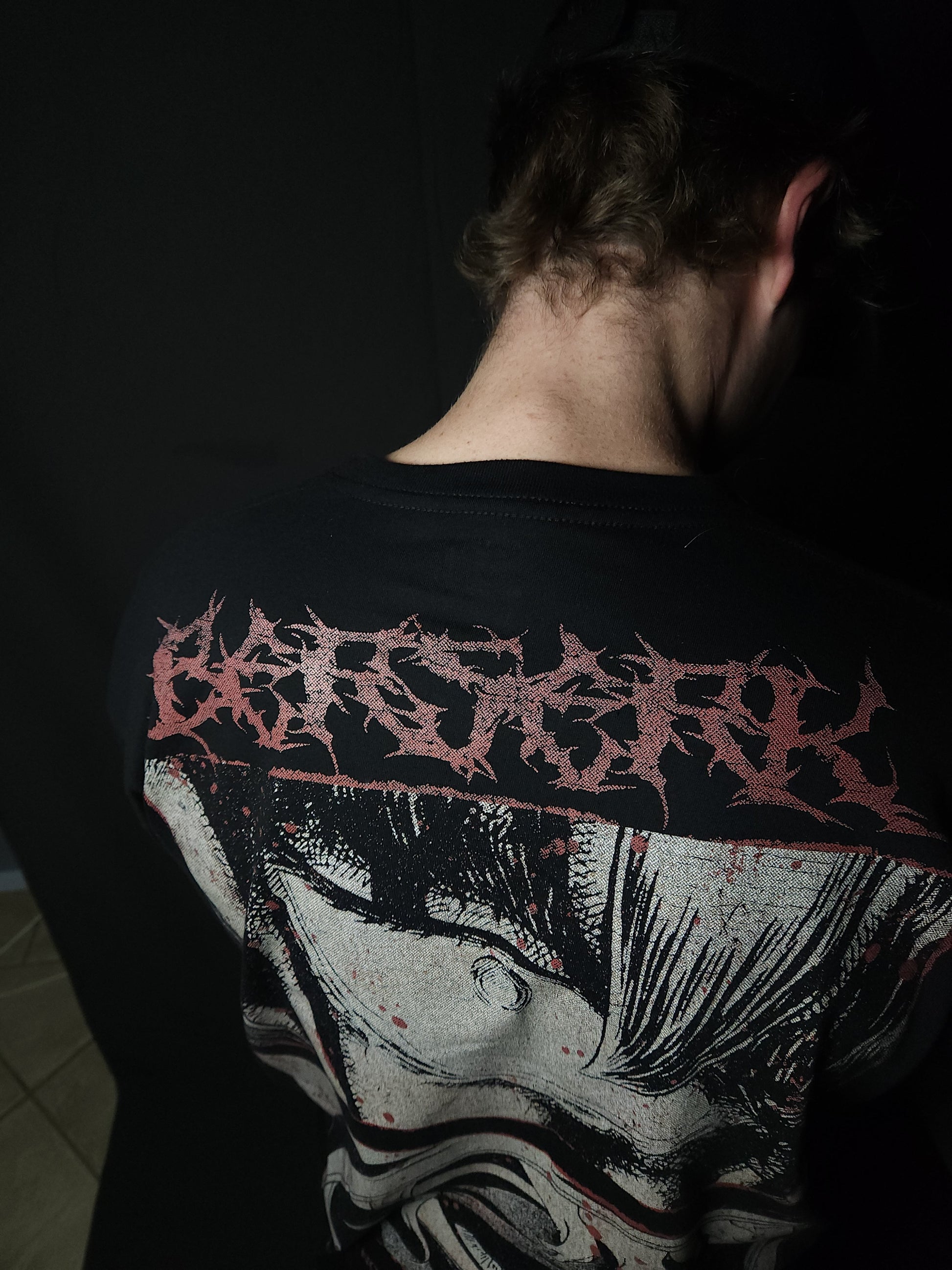 Anime-inspired apparel featuring bold back artwork, worn by a model in a dark studio setting – from a South African anime clothing brand.