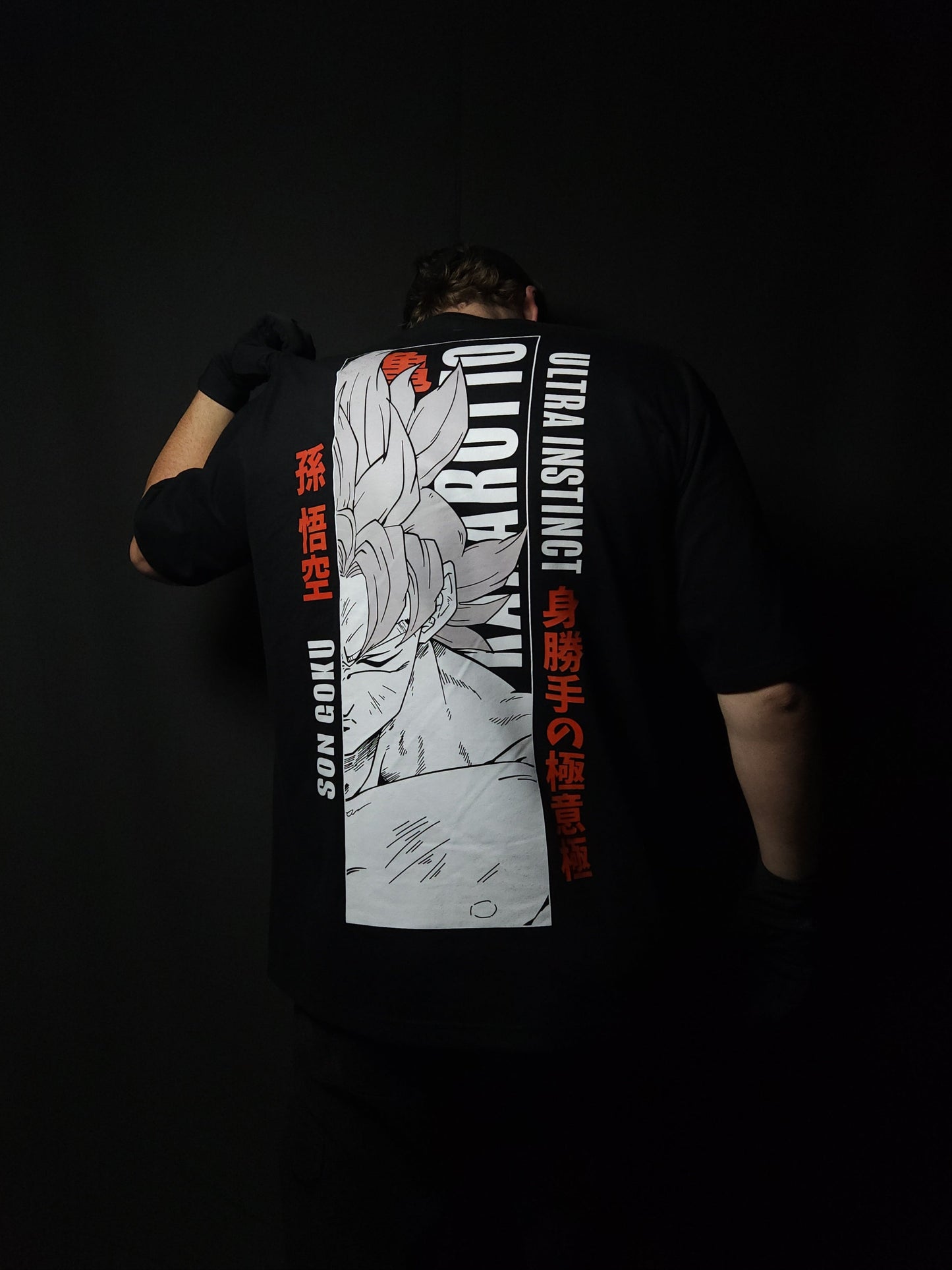 Anime-inspired apparel featuring bold back artwork, worn by a model in a dark studio setting – from a South African anime clothing brand.