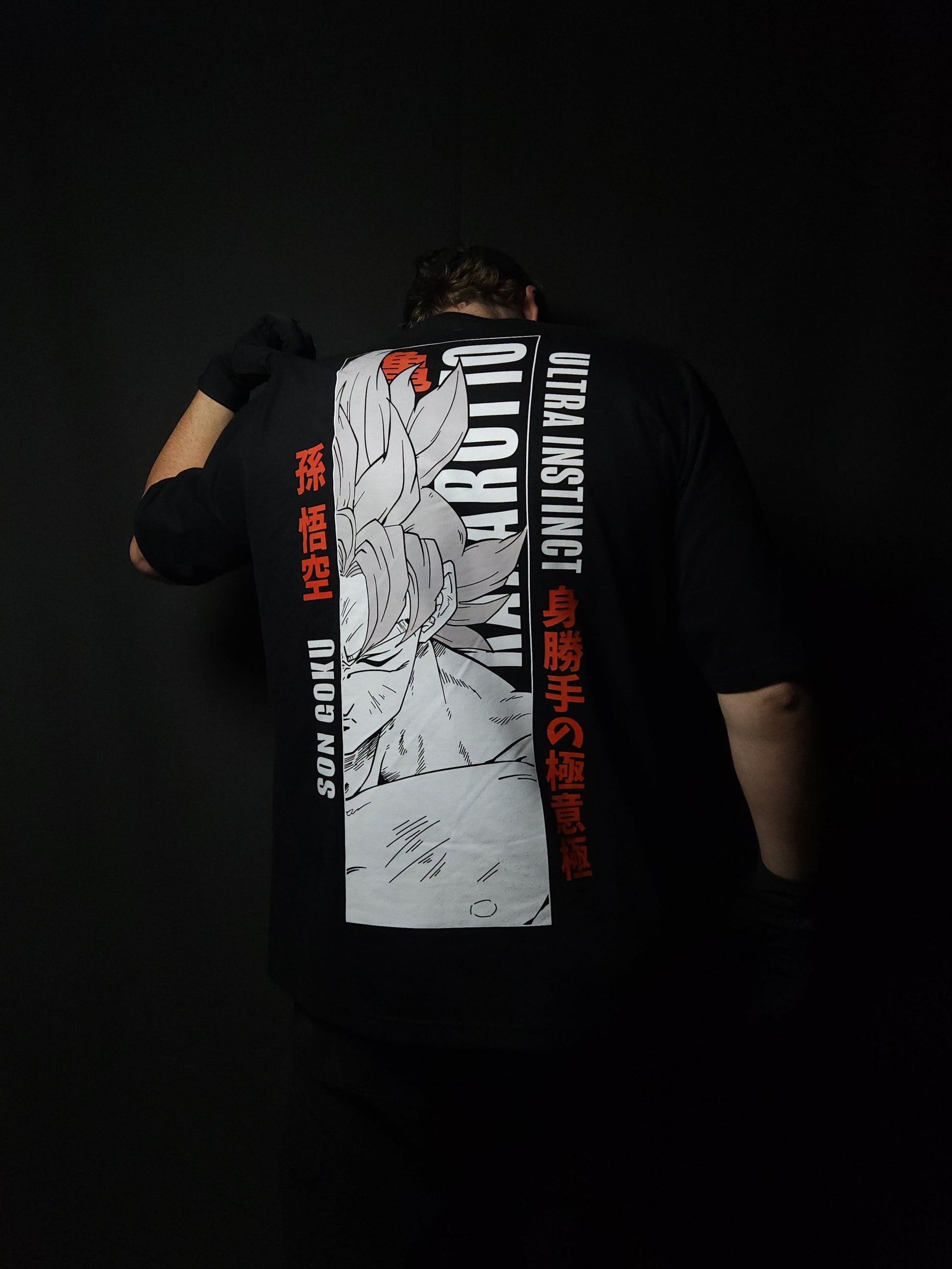 Anime-inspired apparel featuring bold back artwork, worn by a model in a dark studio setting – from a South African anime clothing brand.