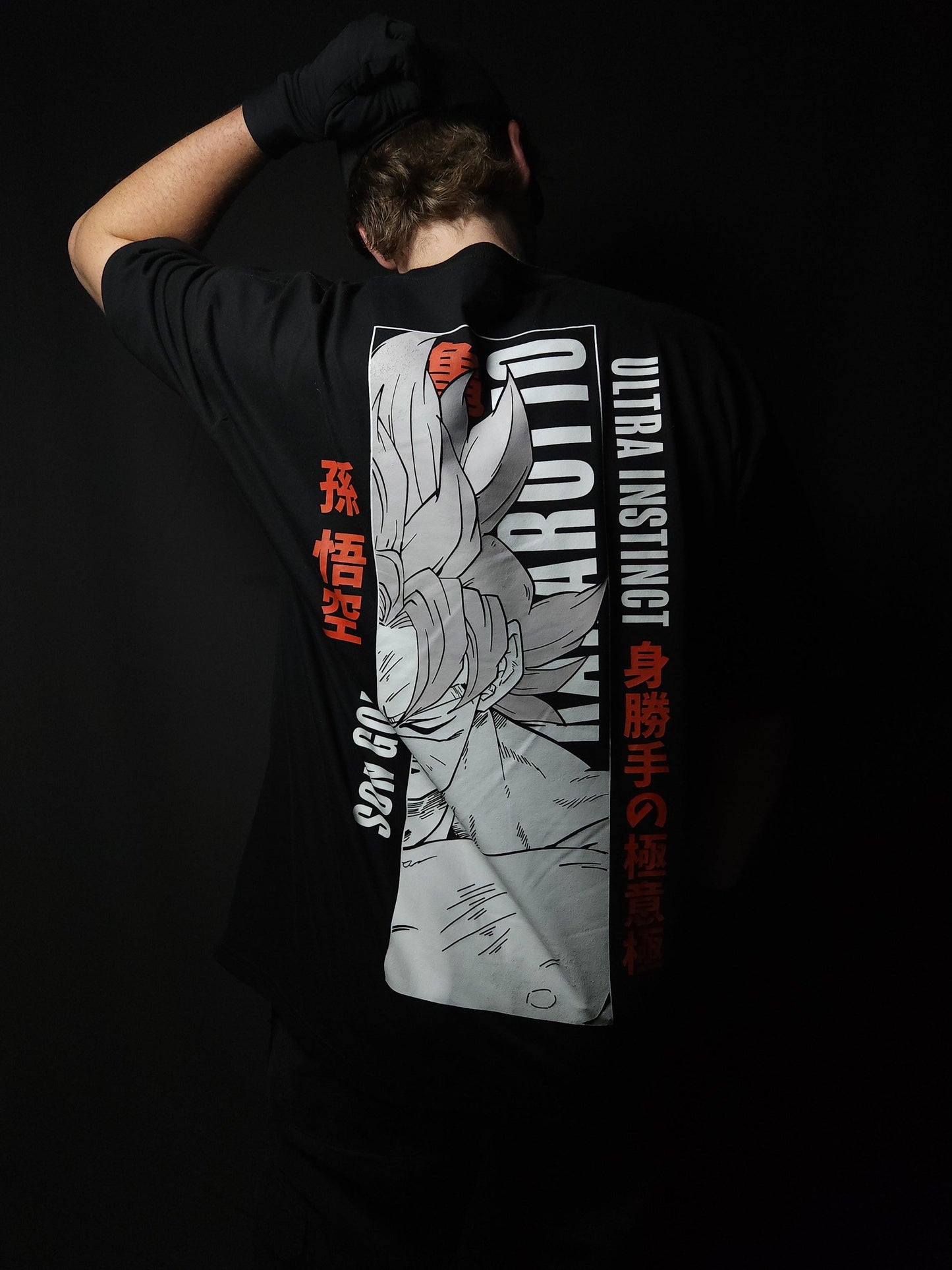 Anime-inspired apparel featuring bold back artwork, worn by a model in a dark studio setting – from a South African anime clothing brand.