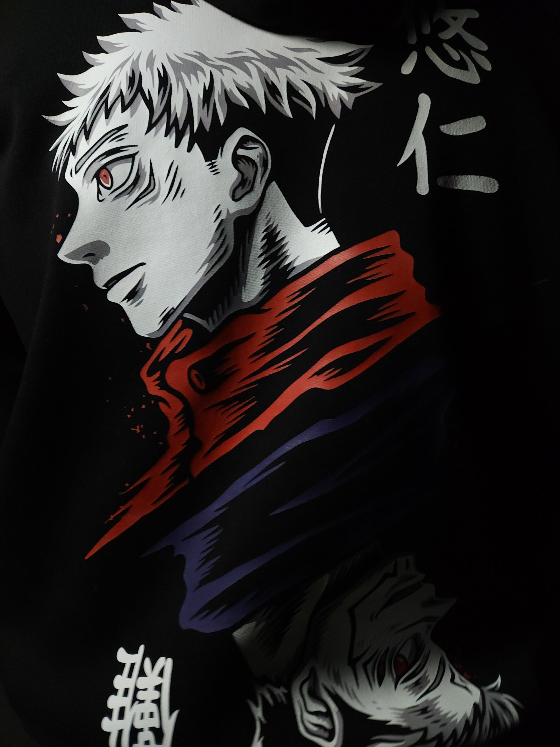 Anime-inspired apparel featuring bold back artwork, worn by a model in a dark studio setting – from a South African anime clothing brand.