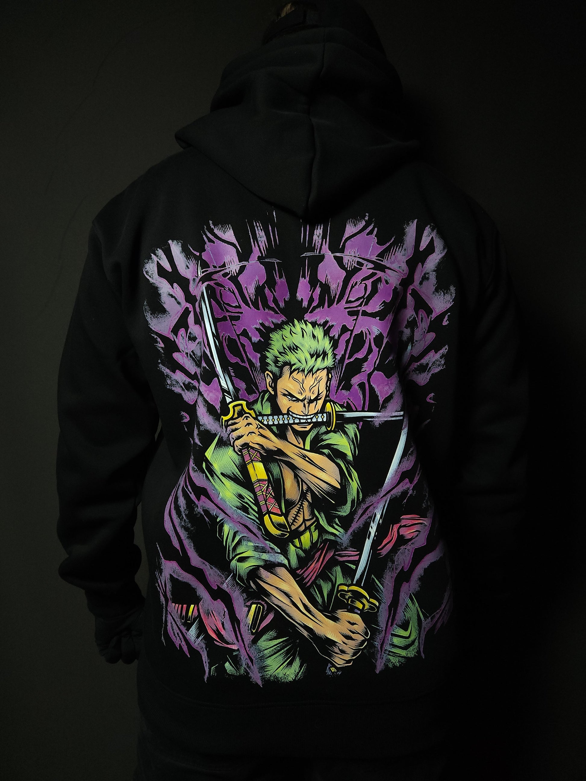 Anime-inspired apparel featuring bold back artwork, worn by a model in a dark studio setting – from a South African anime clothing brand.