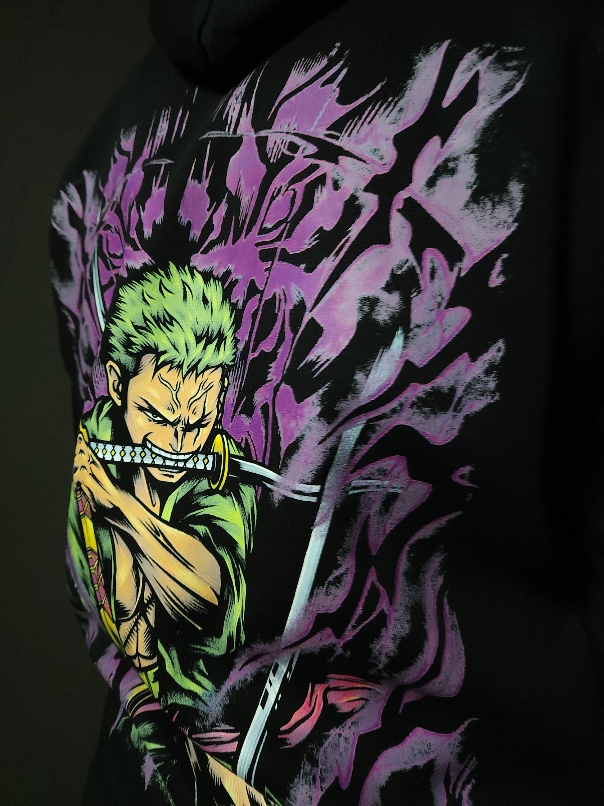 Anime-inspired apparel featuring bold back artwork, worn by a model in a dark studio setting – from a South African anime clothing brand.