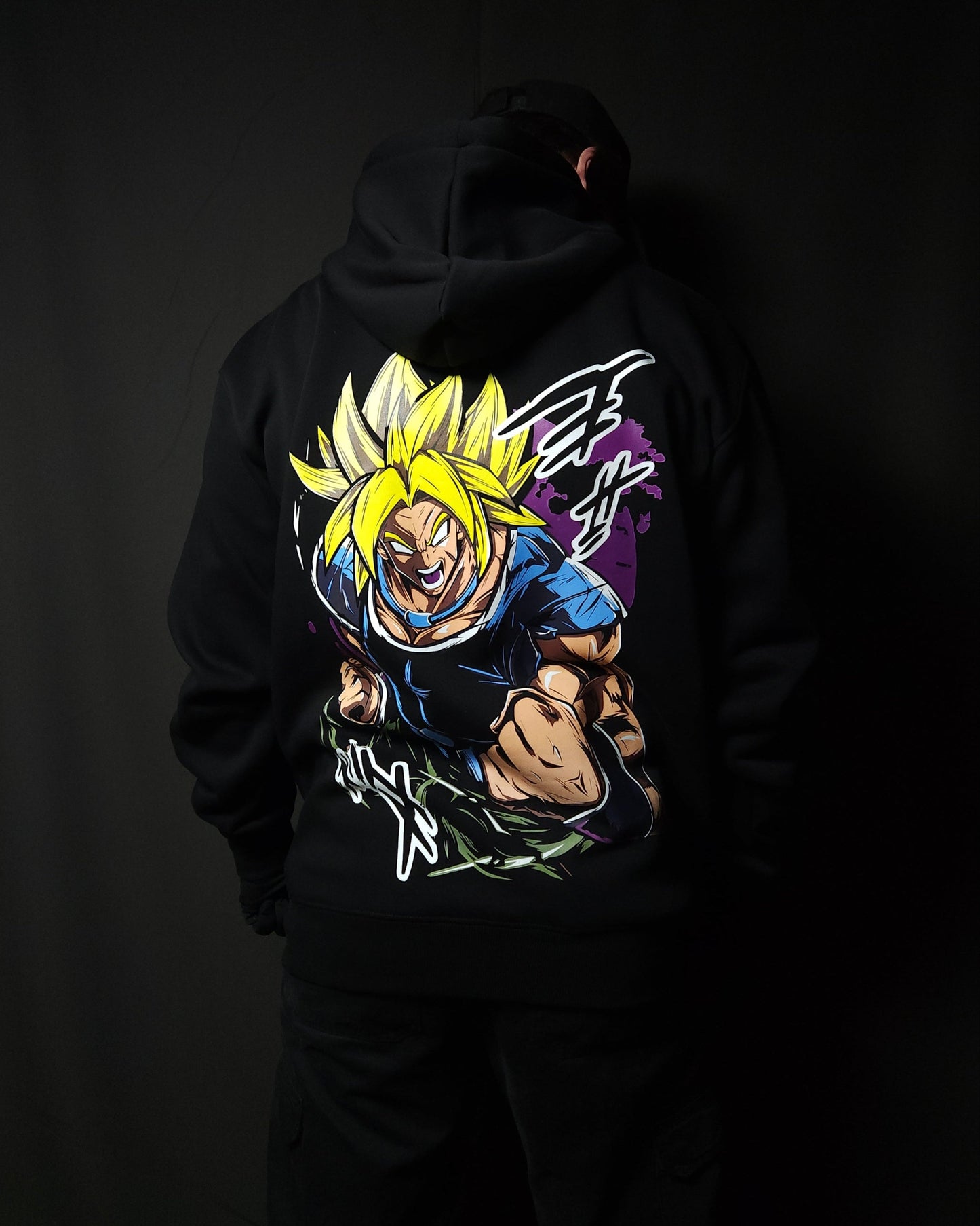 Anime-inspired apparel featuring bold back artwork, worn by a model in a dark studio setting – from a South African anime clothing brand.