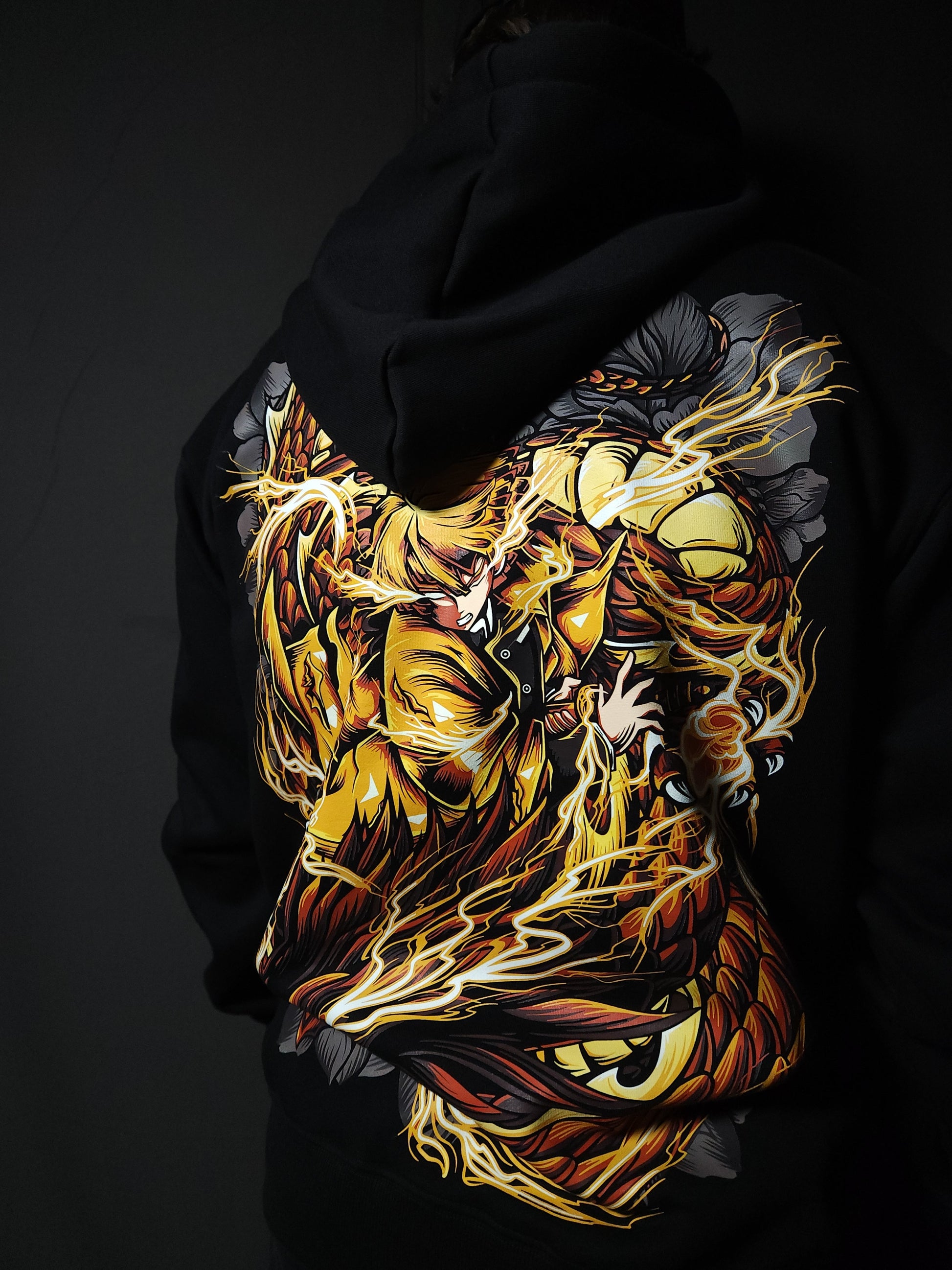 Anime-inspired apparel featuring bold back artwork, worn by a model in a dark studio setting – from a South African anime clothing brand.