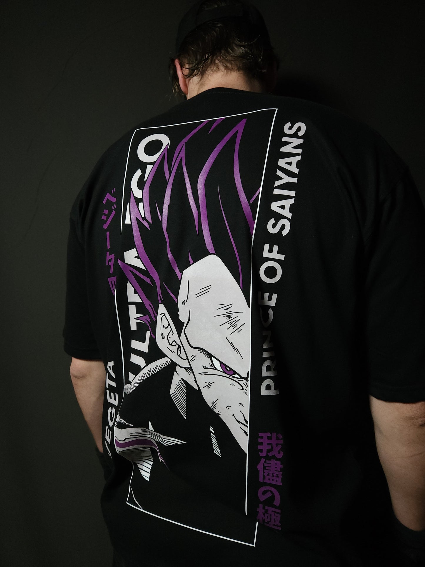 Anime-inspired apparel featuring bold back artwork, worn by a model in a dark studio setting – from a South African anime clothing brand.