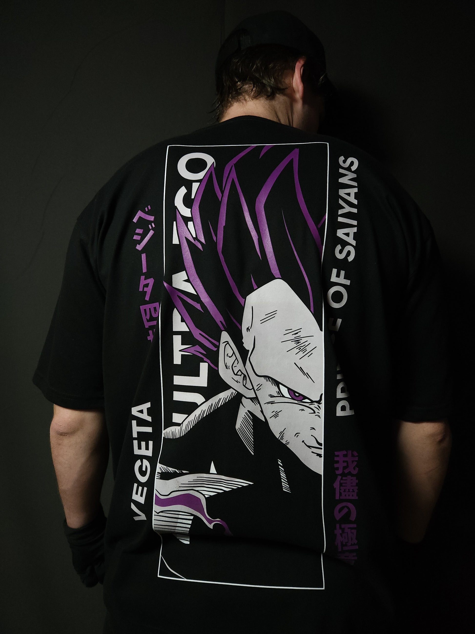 Anime-inspired apparel featuring bold back artwork, worn by a model in a dark studio setting – from a South African anime clothing brand.