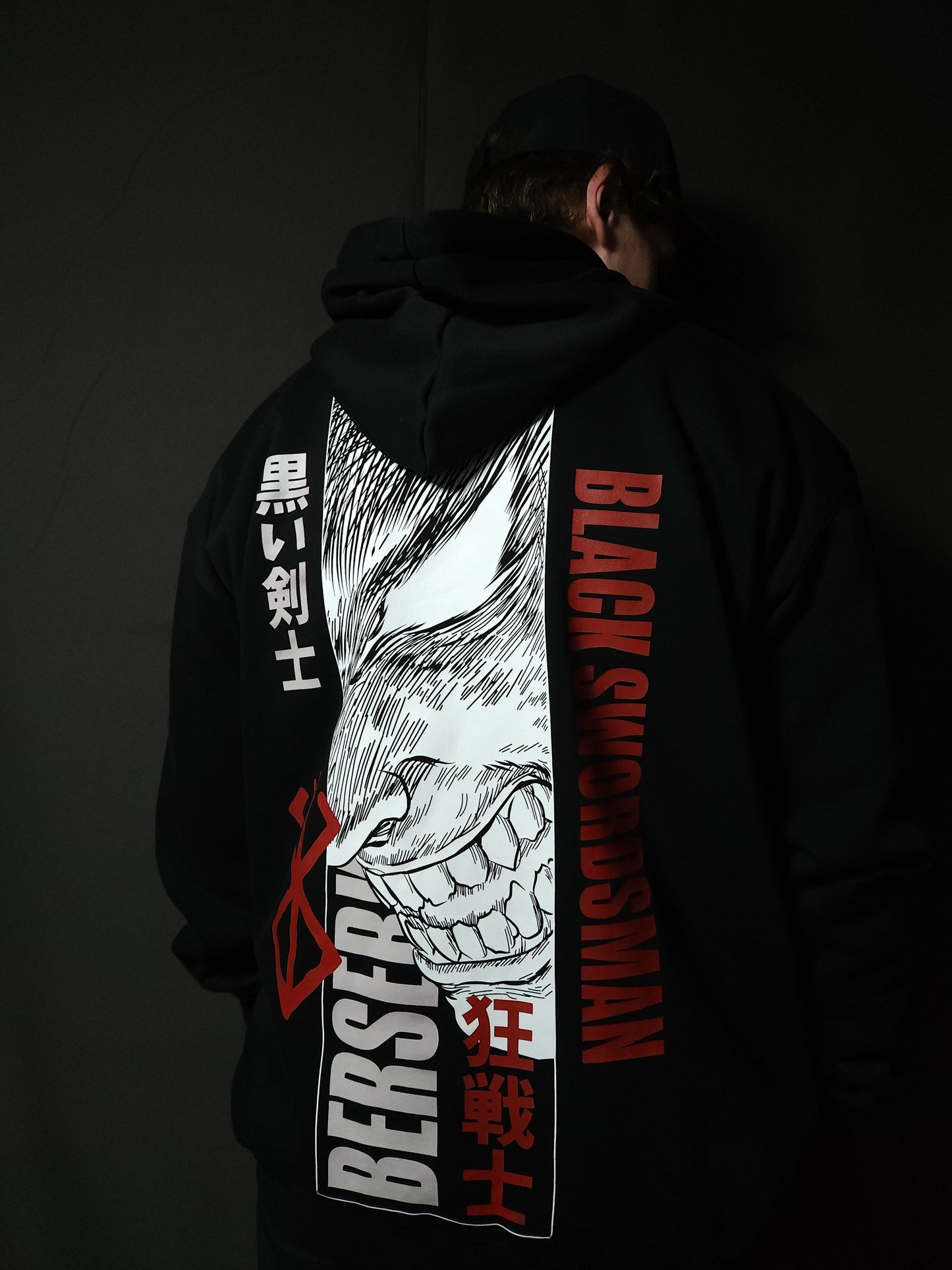 Anime-inspired apparel featuring bold back artwork, worn by a model in a dark studio setting – from a South African anime clothing brand.