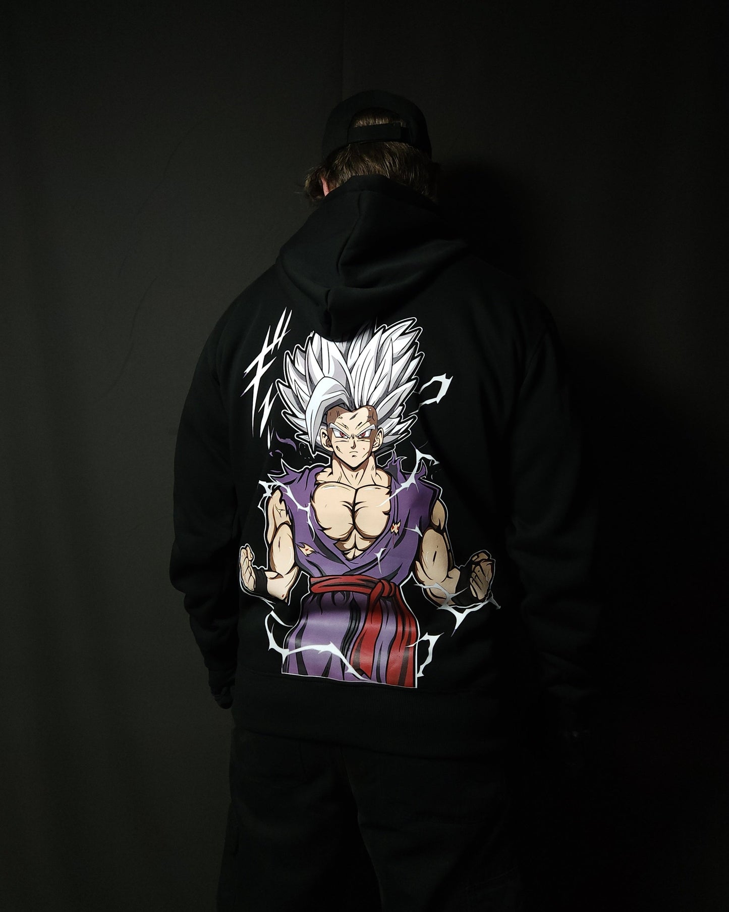 Anime-inspired apparel featuring bold back artwork, worn by a model in a dark studio setting – from a South African anime clothing brand.