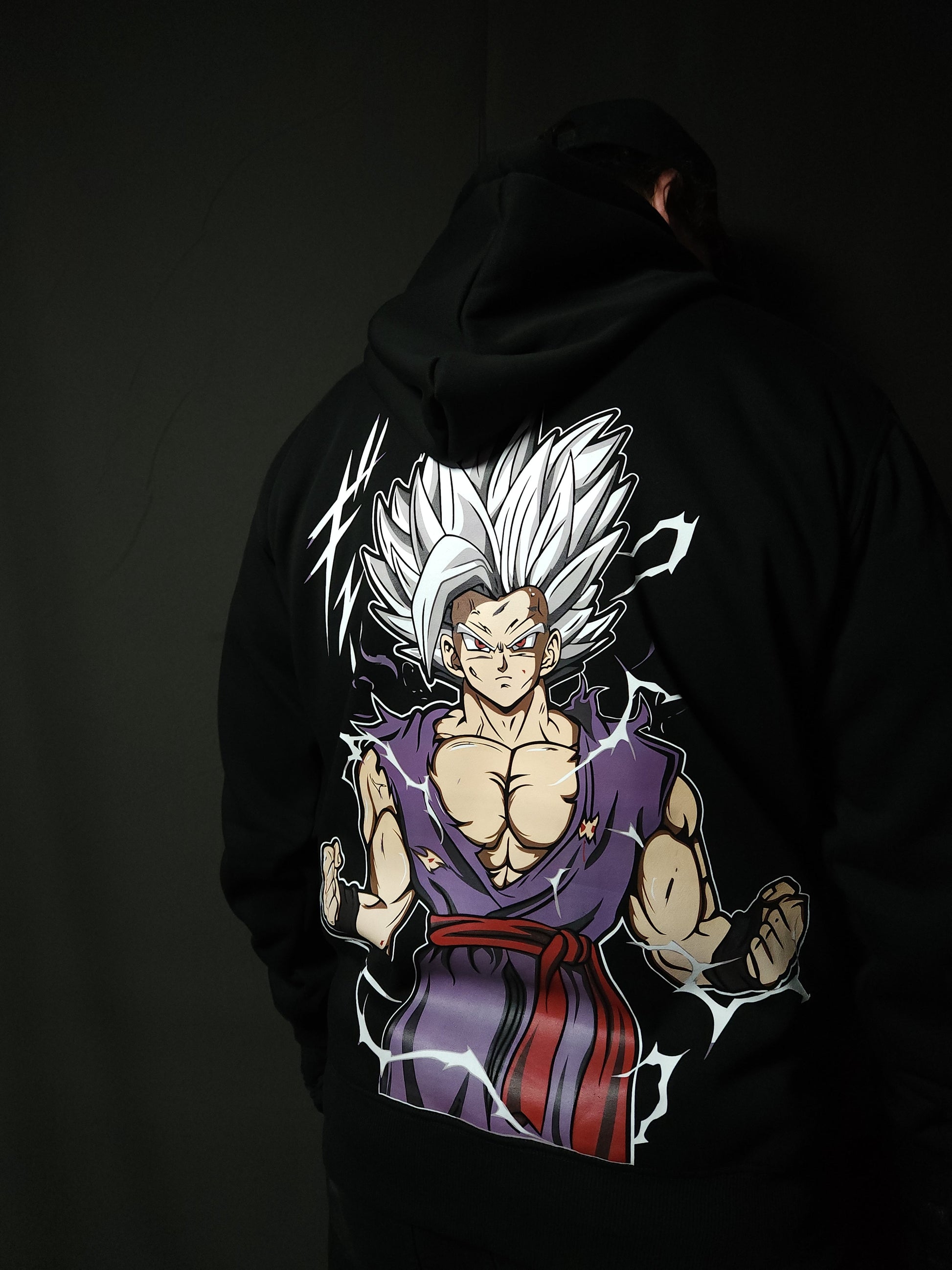 Anime-inspired apparel featuring bold back artwork, worn by a model in a dark studio setting – from a South African anime clothing brand.