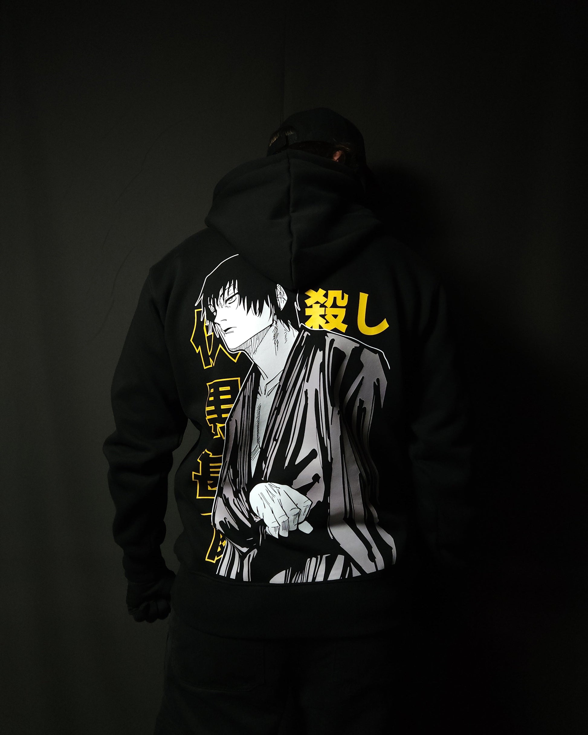 Anime-inspired apparel featuring bold back artwork, worn by a model in a dark studio setting – from a South African anime clothing brand.