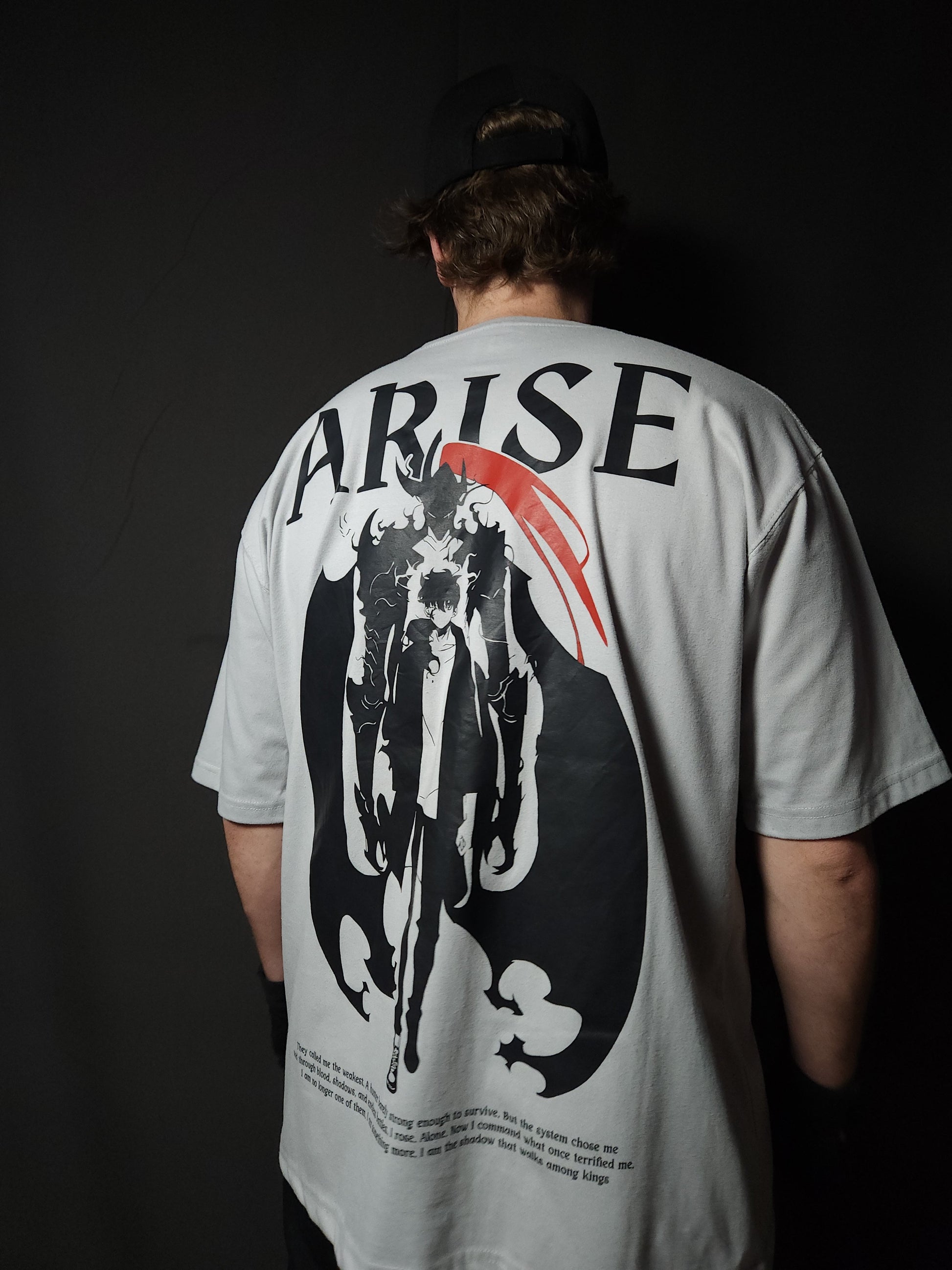 Anime-inspired apparel featuring bold back artwork, worn by a model in a dark studio setting – from a South African anime clothing brand.