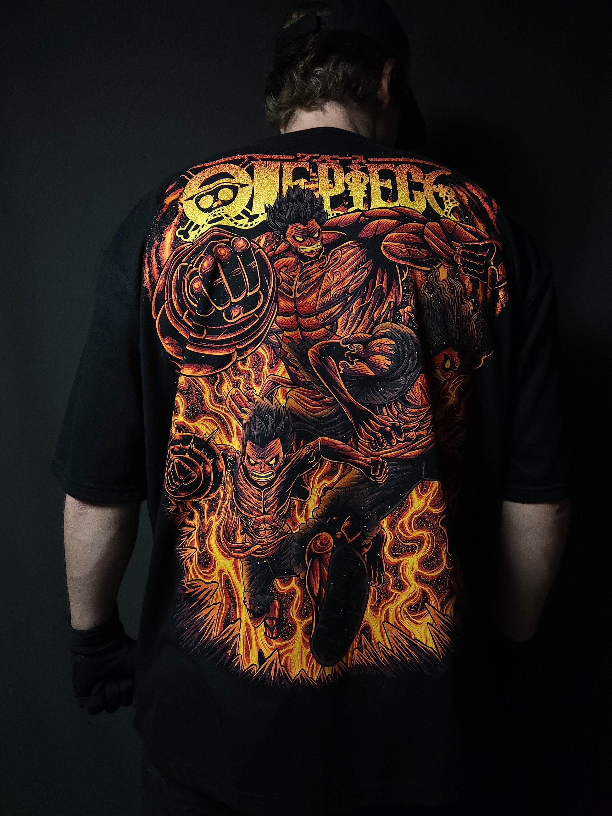 Anime-inspired apparel featuring bold back artwork, worn by a model in a dark studio setting – from a South African anime clothing brand.