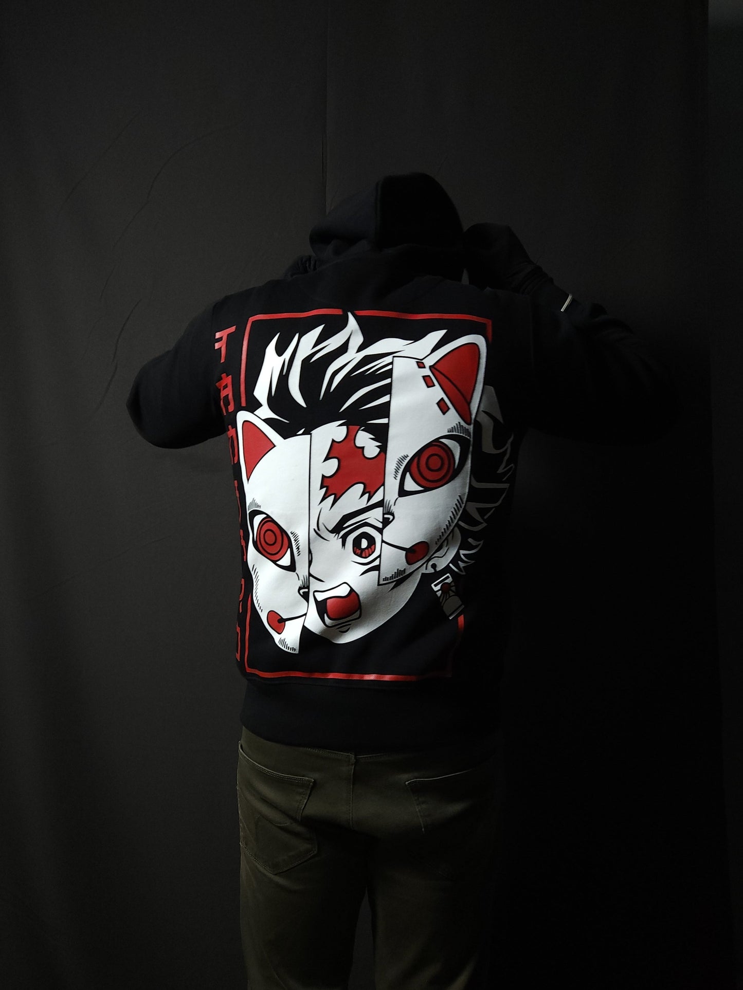 Anime-inspired apparel featuring bold back artwork, worn by a model in a dark studio setting – from a South African anime clothing brand.