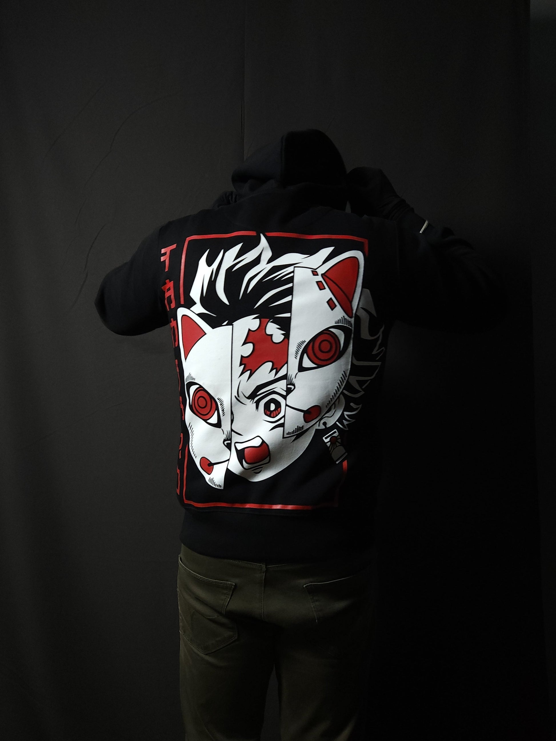 Anime-inspired apparel featuring bold back artwork, worn by a model in a dark studio setting – from a South African anime clothing brand.