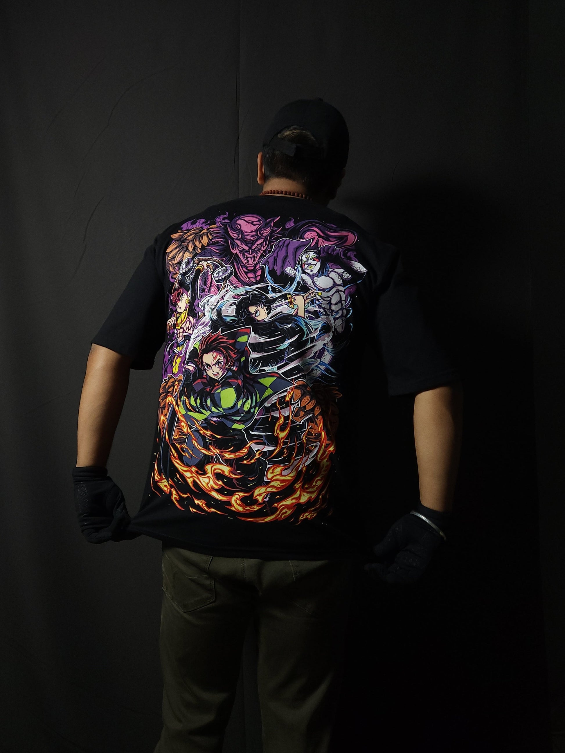 Anime-inspired apparel featuring bold back artwork, worn by a model in a dark studio setting – from a South African anime clothing brand.