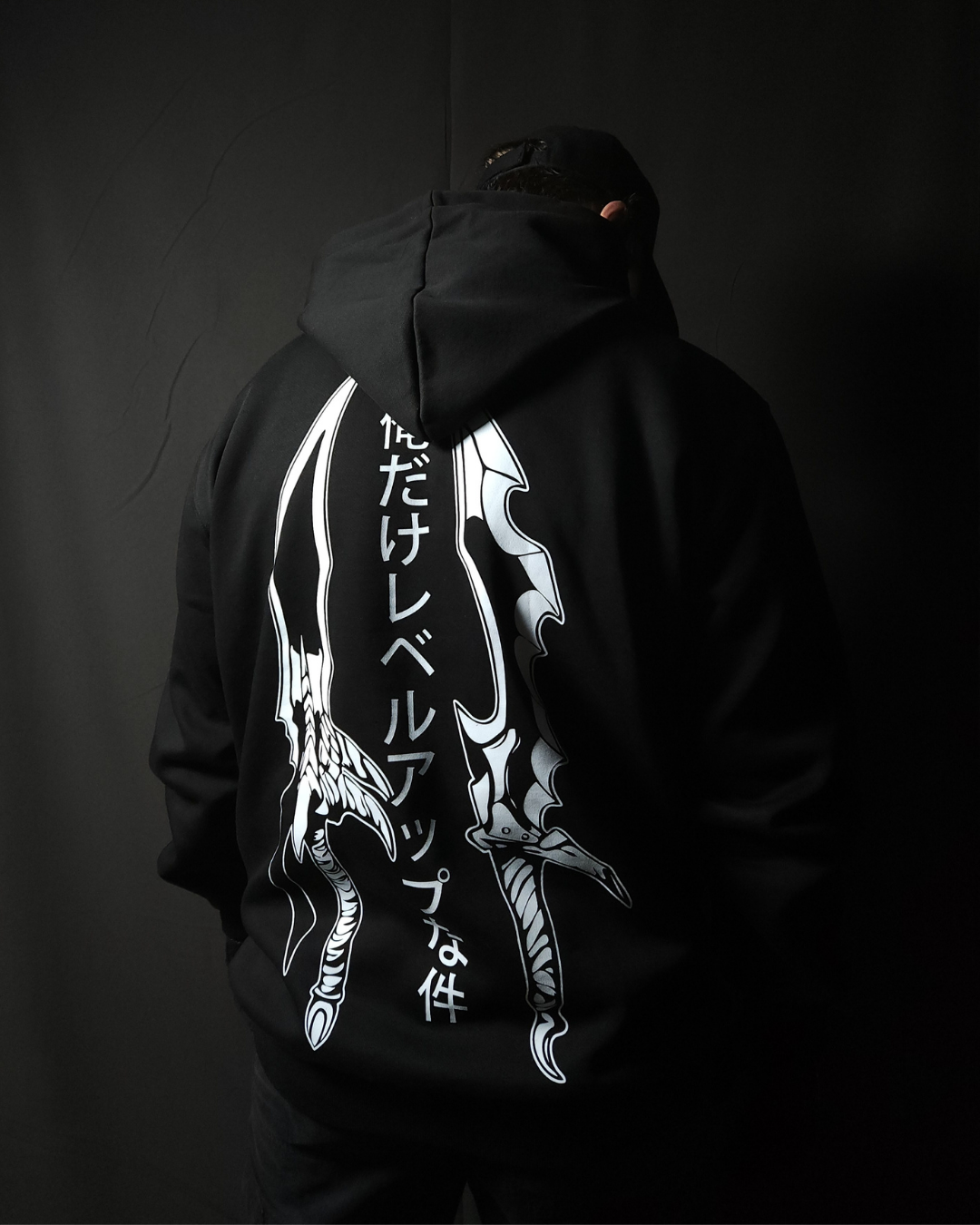 Anime-inspired apparel featuring bold back artwork, worn by a model in a dark studio setting – from a South African anime clothing brand.
