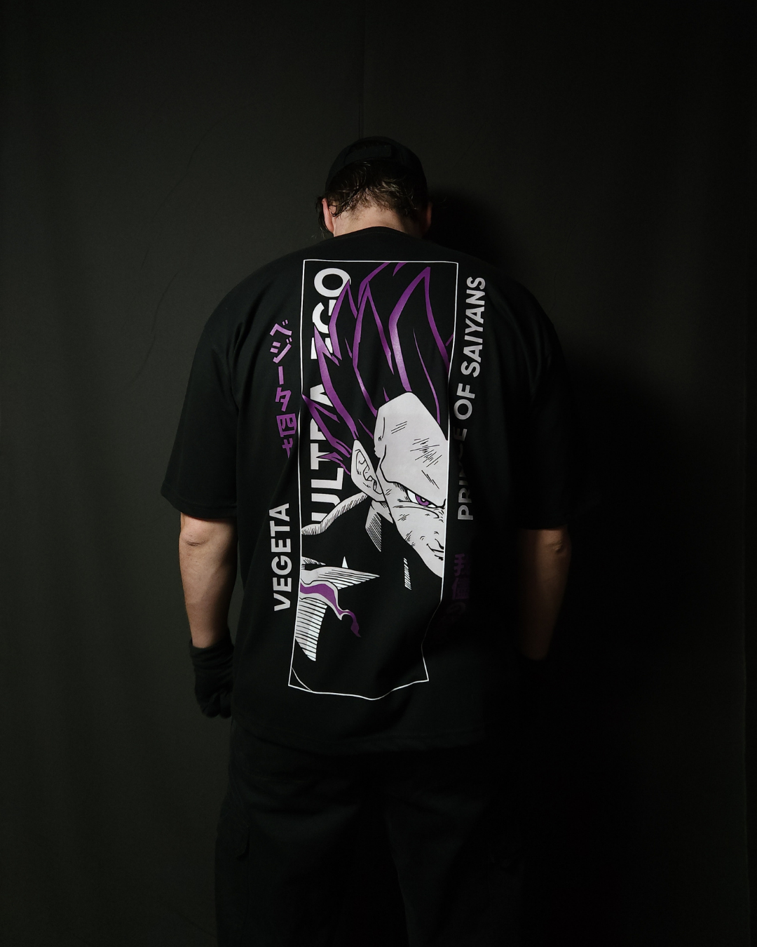 Anime-inspired apparel featuring bold back artwork, worn by a model in a dark studio setting – from a South African anime clothing brand.
