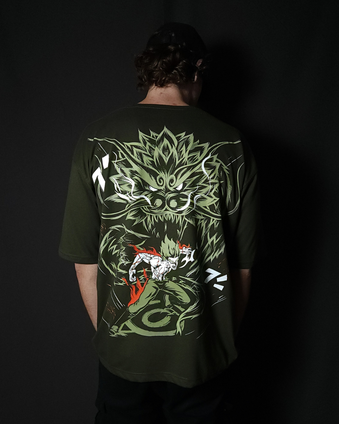 Anime-inspired apparel featuring bold Naruto back artwork, worn by a model in a dark studio setting – from a South African anime clothing brand.