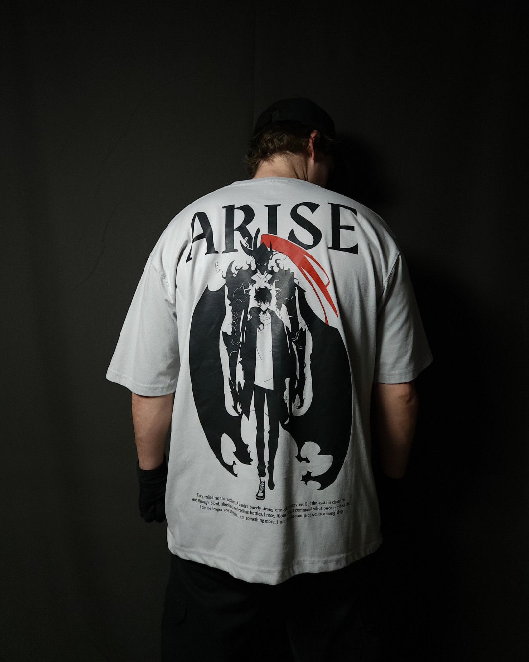 Anime-inspired apparel featuring bold back artwork, worn by a model in a dark studio setting – from a South African anime clothing brand.